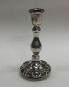 A small silver chamber stick with scroll decoratio