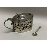 An Edwardian silver mustard pot and spoon. Birming