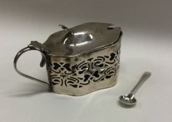 An Edwardian silver mustard pot and spoon. Birming