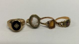 A group of four 9 carat gold rings. Approx. 10.4 g