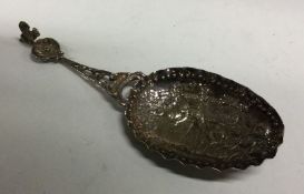 An oversized chased silver caddy spoon bearing Ger