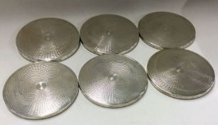 A set of six silver bottle coasters with engine tu