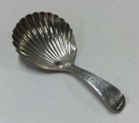 A George III silver caddy spoon with engraved hand