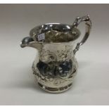 WITHDRAWN: A heavy Victorian silver jug embossed