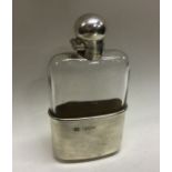 A heavy Victorian silver mounted glass flask with