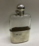 A heavy Victorian silver mounted glass flask with