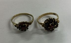 A garnet cluster ring together with one other. Approx. 4.3 grams. Est. £70