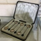 A boxed set of six silver bean top coffee spoons.