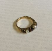 A 9 carat pearl and garnet half hoop ring. Approx.