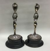 A pair of silver mounted figures in the form of la