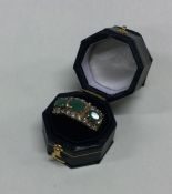A good emerald and diamond three row ring in 9 car