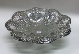 A large silver bonbon dish with scroll decoration.