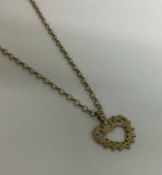 A 9 carat pendant on fine link chain. Approx. 2.6