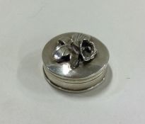 A silver hinged top box with floral decoration. Ap