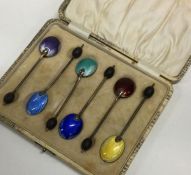 A cased set of six silver and enamelled spoons. Bi
