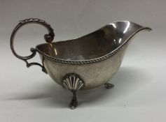 An Edwardian silver sauce boat with gadroon rim. B