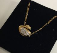 A heavy 18 carat gold diamond pendant in the form