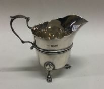 An attractive silver cream jug with shaped rim. Sh