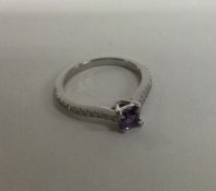 An attractive amethyst and diamond ring in platinu