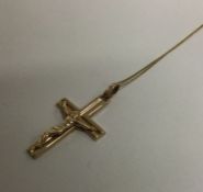 A heavy 9 carat crucifix on fine link chain. Appro