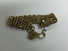 A 9 carat gate bracelet with heart shaped padlock.