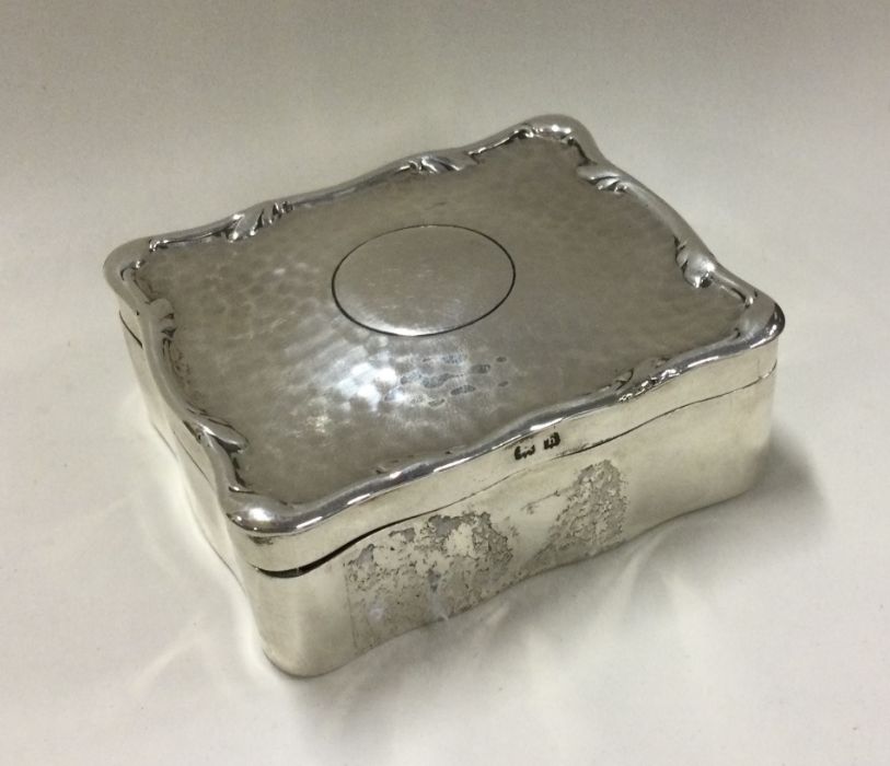 An unusual silver jewellery box with hammered text