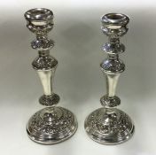 A pair of large heavy chased silver candlesticks.