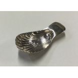 A George III silver caddy spoon with fluted bowl.