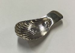 A George III silver caddy spoon with fluted bowl.