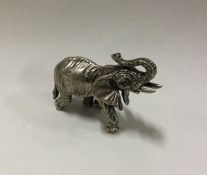 A silver figure of an elephant in standing positio
