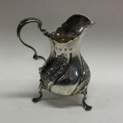 An attractive chased silver cream jug decorated wi