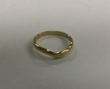 A plain shaped 18 carat gold wedding band. Approx.