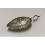 A George III silver caddy spoon in the form of a l