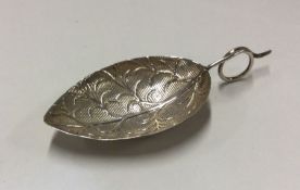 A George III silver caddy spoon in the form of a l