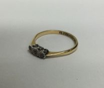 An 18 carat diamond three stone ring. Approx. 2.3