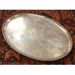 A large Georgian silver tray on four sweeping feet