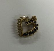A 9 carat sapphire mounted heart. Approx. 4.5 gram