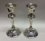 A tall pair of silver candlesticks with reeded dec