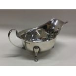 A heavy silver sauce boat with card cut rim. Sheff