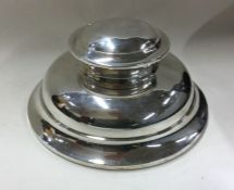 CHESTER: A large circular inkwell with hinged top.
