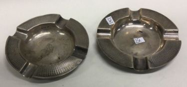 A heavy pair of engine turned silver ashtrays. App
