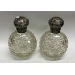 A pair of hobnail cut silver scent bottles. Est. £