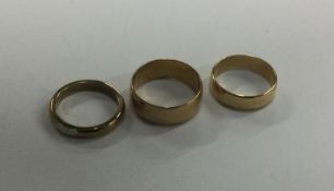 A group of three heavy plain 9 carat wedding bands