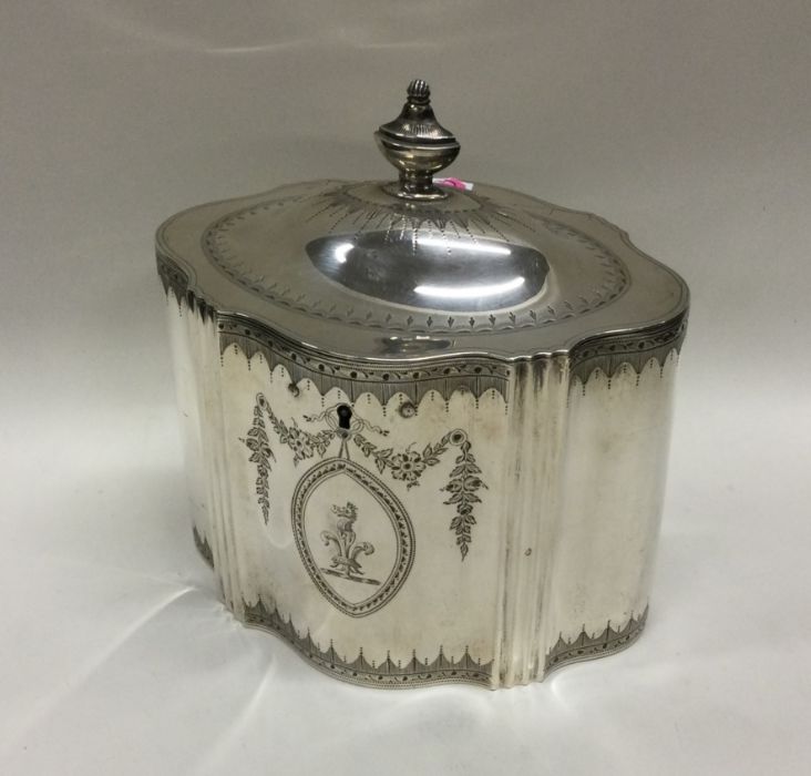 A Georgian silver tea caddy with engraved bright c