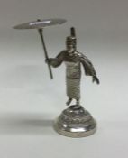A heavy silver figure of a Chinese man holding an