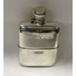 A heavy novelty silver flask with detachable cup.