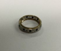 A small sapphire and diamond wedding band in two c