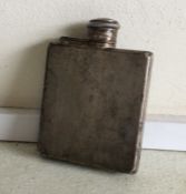 An engine turned silver hip flask with hinged top.
