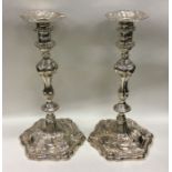 A pair of cast George III silver candlesticks. Lon