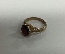 A 9 carat garnet single stone ring. Approx. 3.1 gr